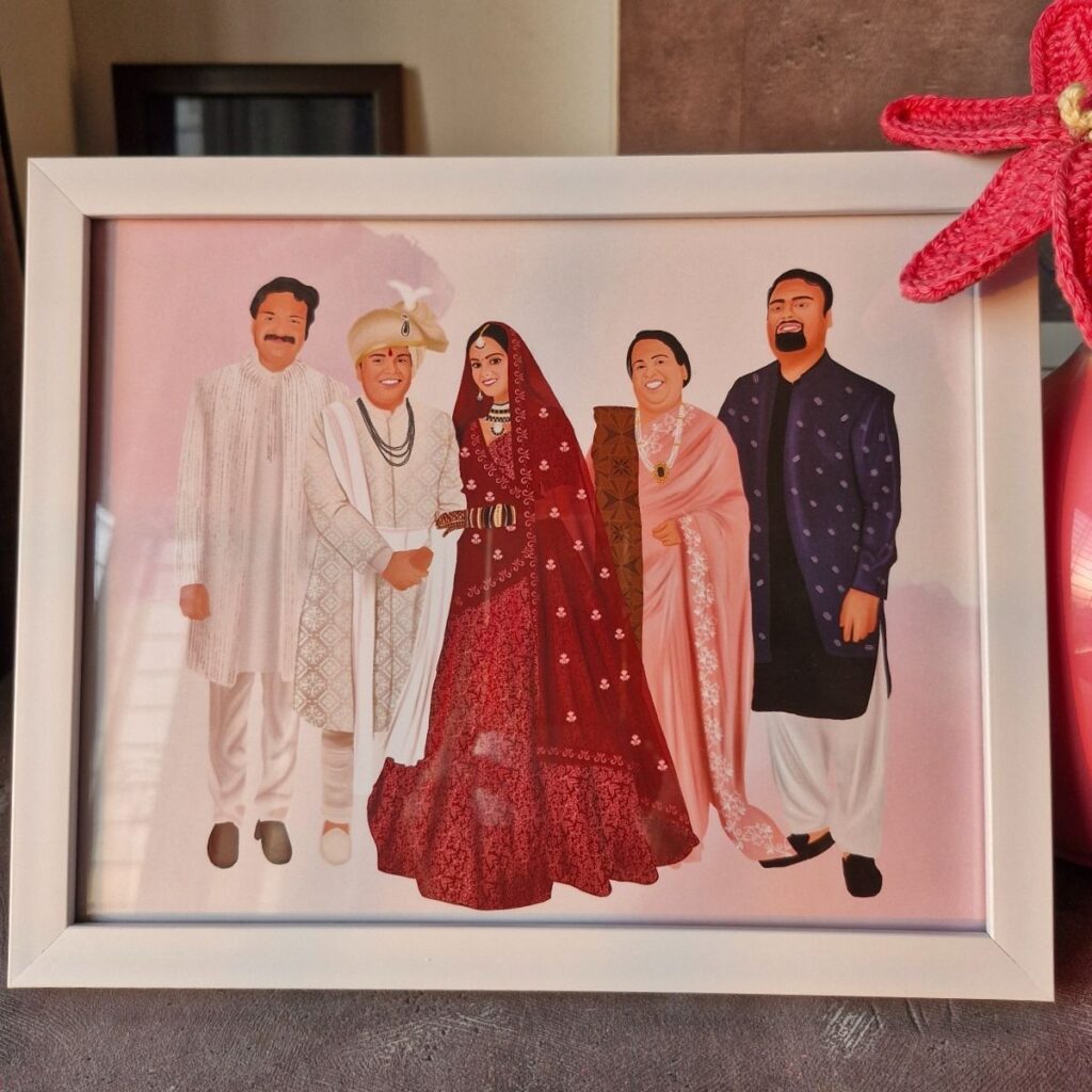Framed illustration of five people in traditional indian wedding attire, with one woman in a bridal outfit standing in the center.